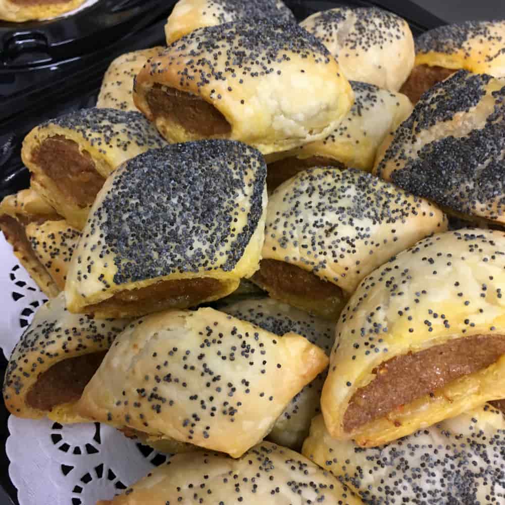 You are looking at a small stack of sausage rolls dusted with poppy seeds